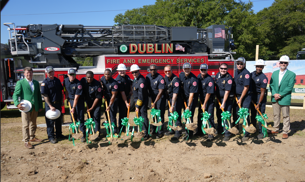 Firefighters standing with shovels, breaking ground